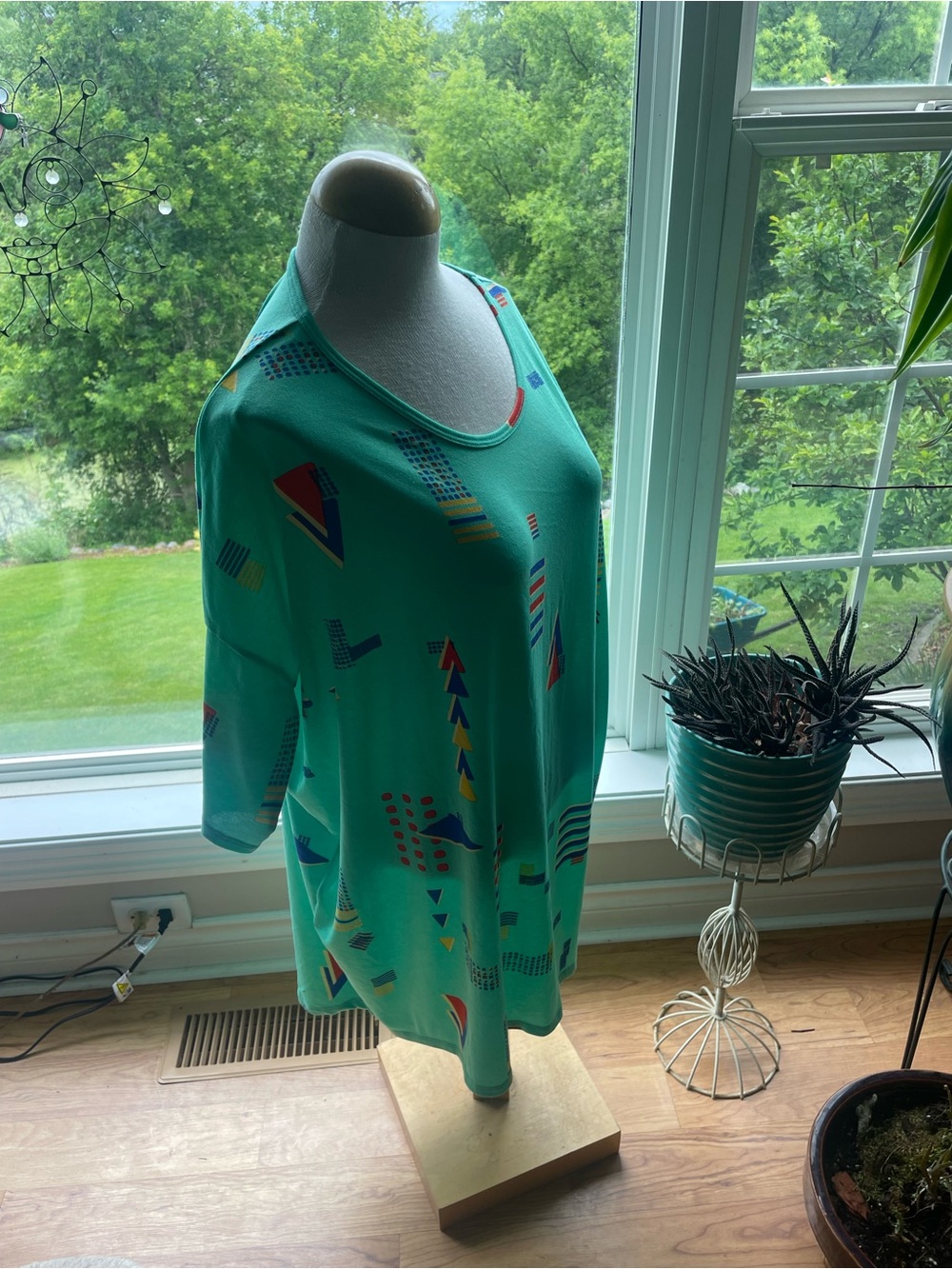 LuLaRoe Teal Tunic Top with Red, Yellow and Blue Geometric Print